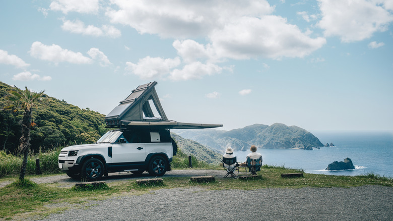 Couple with rooftop tent in nature