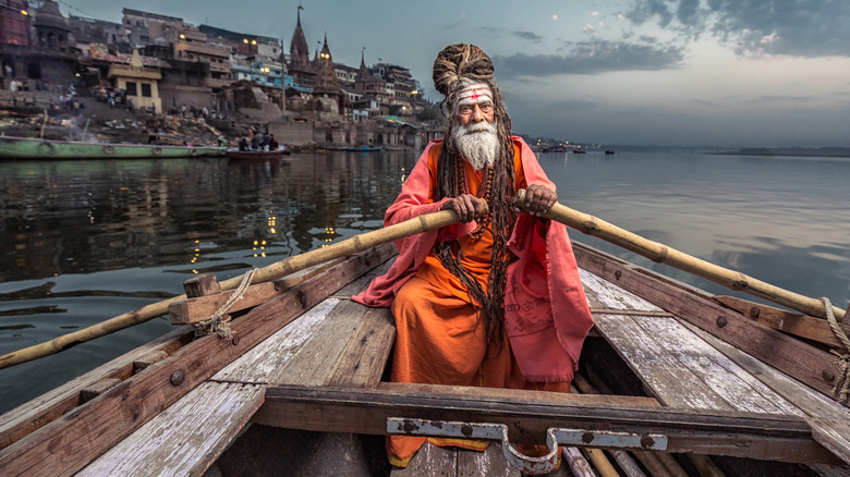 Sadhu driving a boat in Varanasi