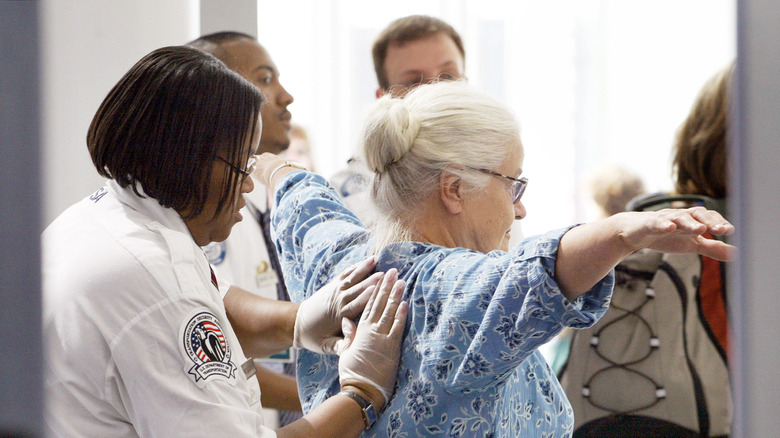 Woman getting a pat-down by TSA officer