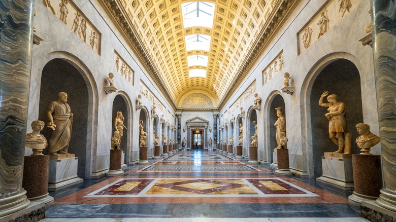 Inside corridor of Vatican Museums with sculptures on either side