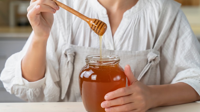 Woman holding fresh honey
