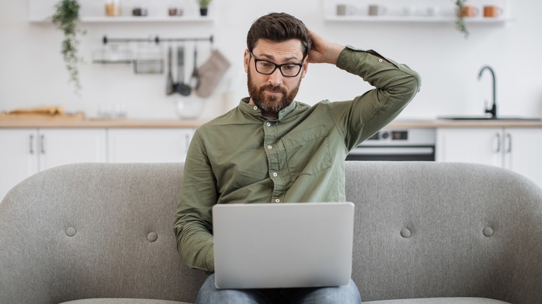 confused man with laptop