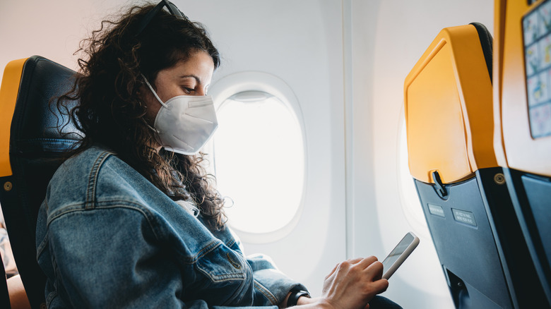 Woman wears mask on flight