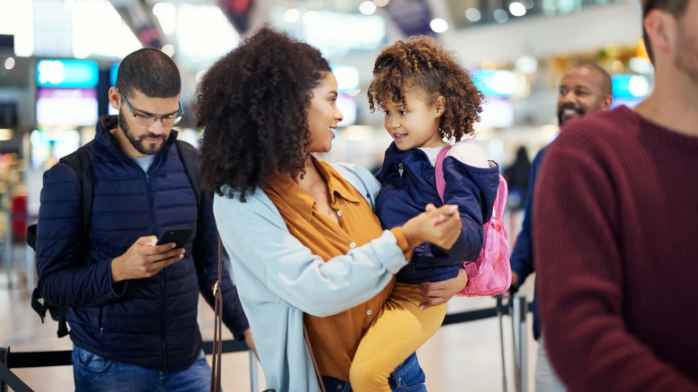 Family boarding airplane together