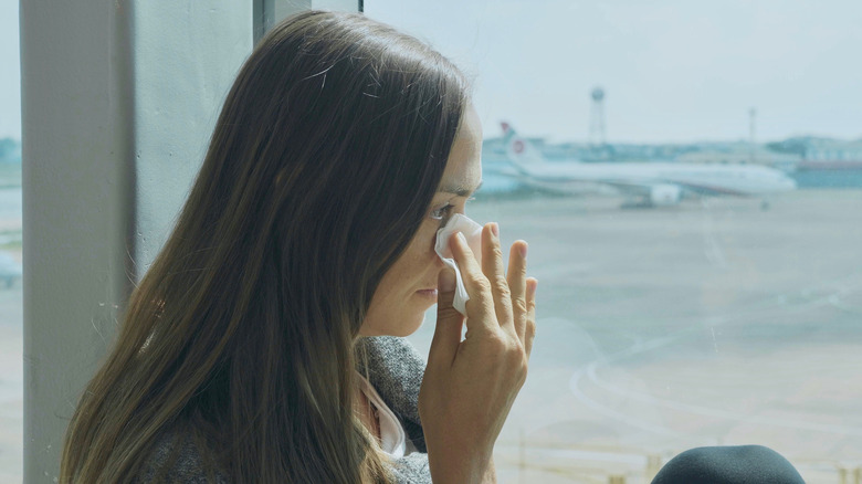 Woman cries in a terminal