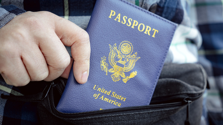 Traveler's hand holding passport