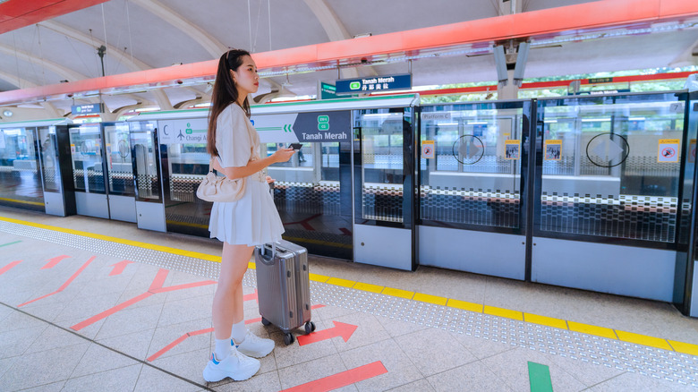 person waiting for subway on platform