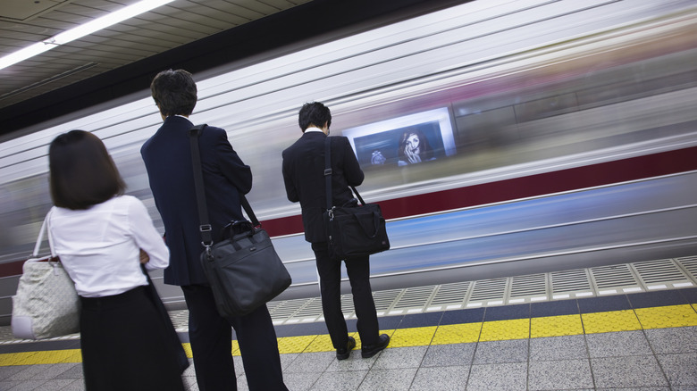 Japanese commuters station platform rushing train