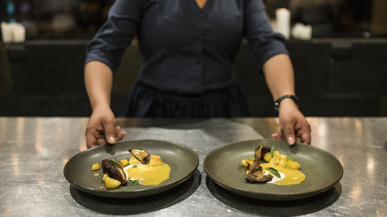 chef holding two dishes