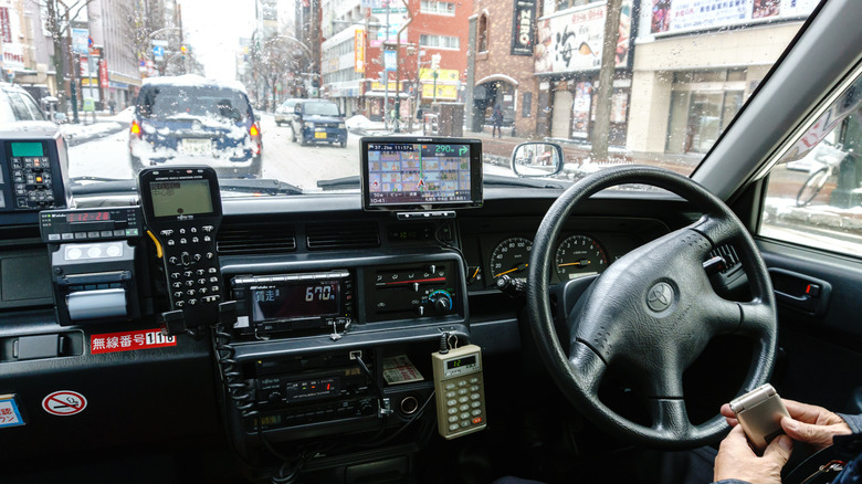 A view of the front of a Japanese taxi from inside