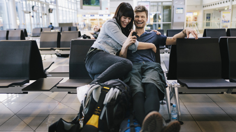 Smiling couple sitting in an airport