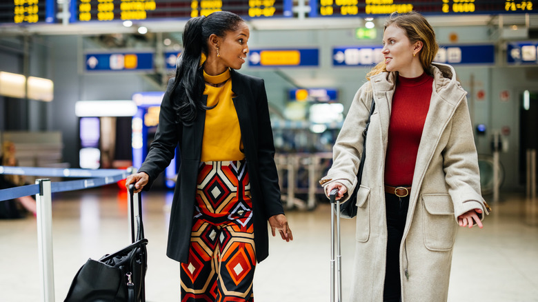 Two well-dressed women at an airport