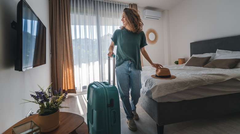 woman in hotel with suitcase