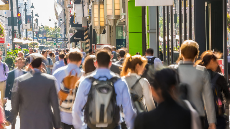 Pedestrians pack a crowded New York street.