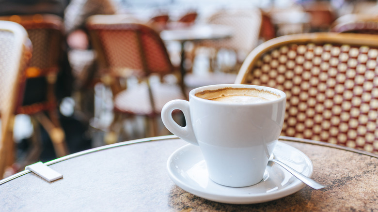 Porcelain coffee cup on a table at a Parisian style cafe