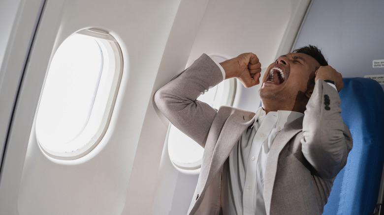 Frustrated man on plane