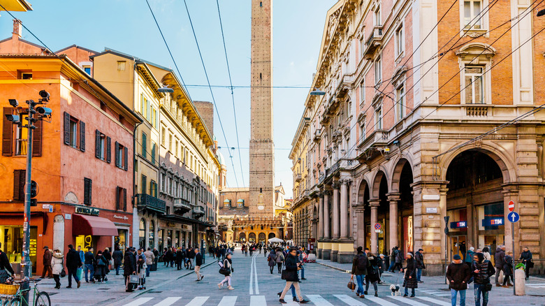 Pedestrians cross a street in an Italian city