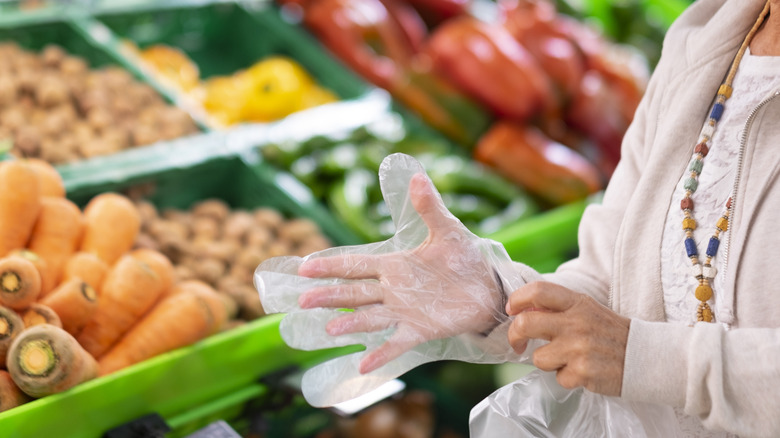 shopper wearing glove near produce