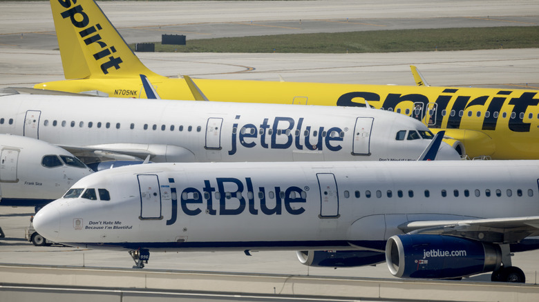 JetBlue and Spirit Airlines planes parked on runway