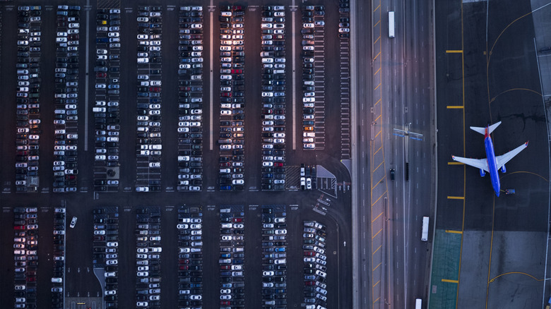 Aerial view of airport parking lot and nearby plane