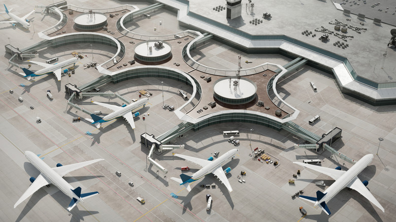 Aerial view of planes, terminal, runway and cars