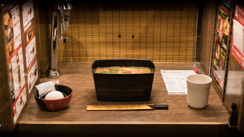 Table with a bowl of ramen noodles