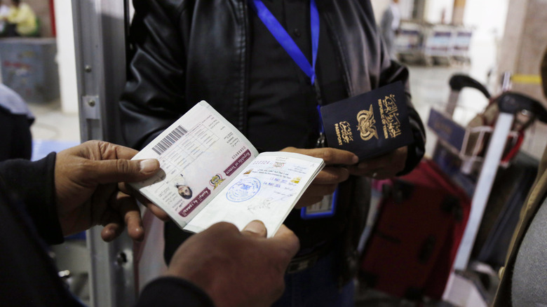 Airport official checking passport