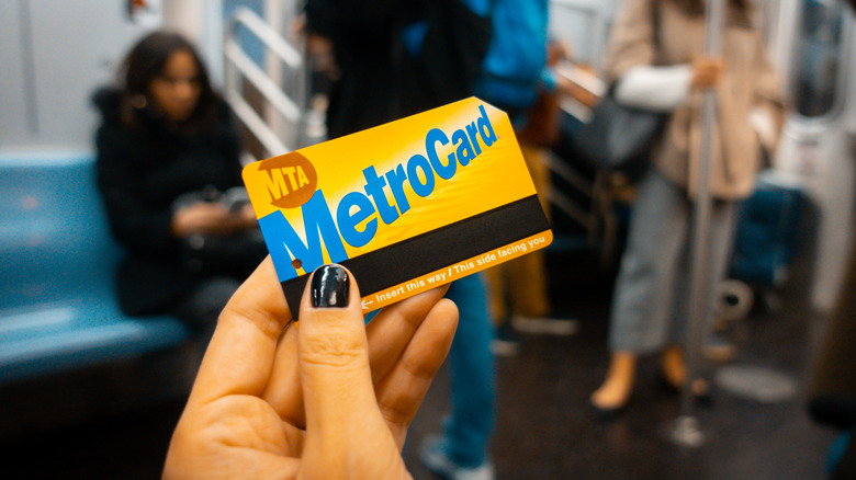 Woman holding a MetroCard