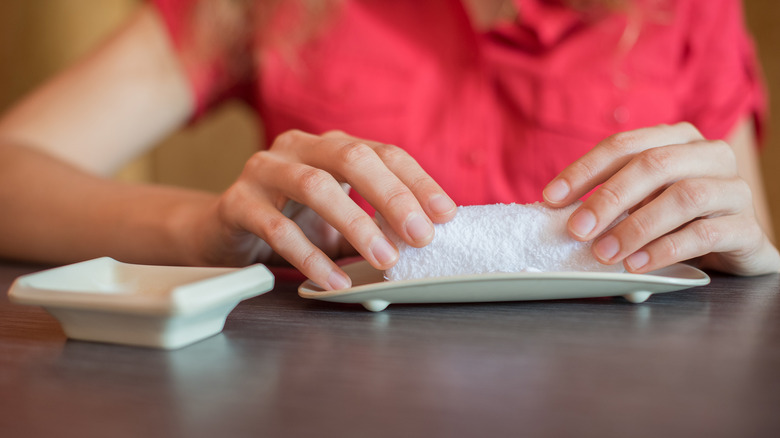 Woman holding oshibori