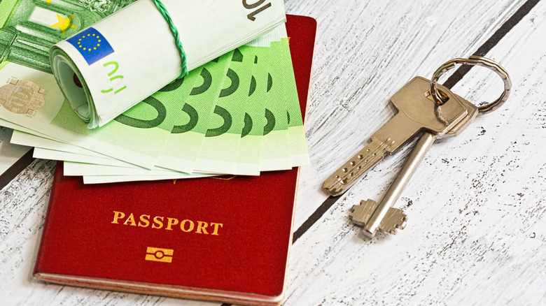 A passport, money, and keys to a home