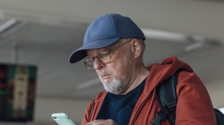 man wearing cap at airport