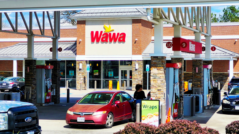 Drivers fill their tanks in front of a Wawa service station