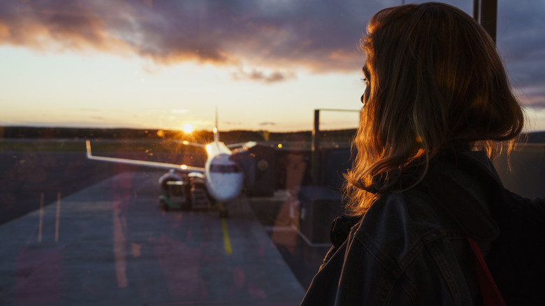 Traveler watching planes from gate