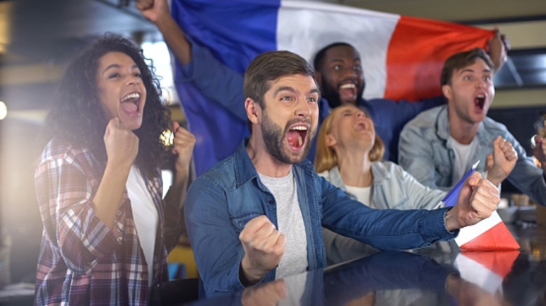 people cheering with french flag