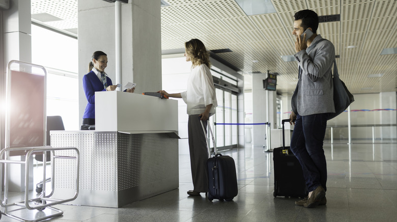 Two passengers standing in boarding queue