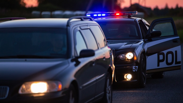 Police stopping car at night