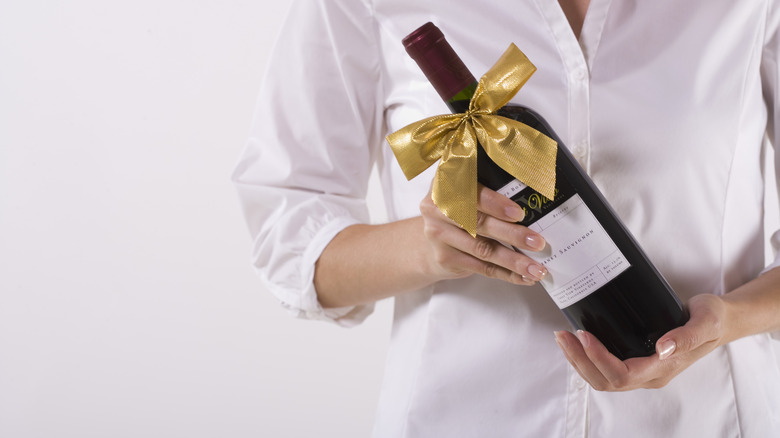 Woman holding wine bottle