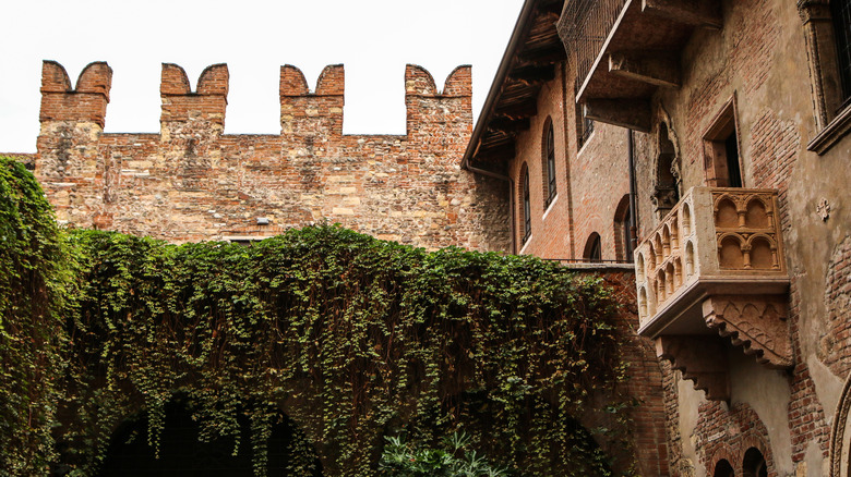 Building with balcony and castle wall, Italy