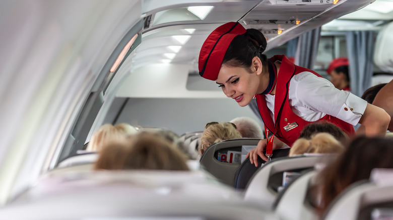 Flight attendant speaking to a passenger