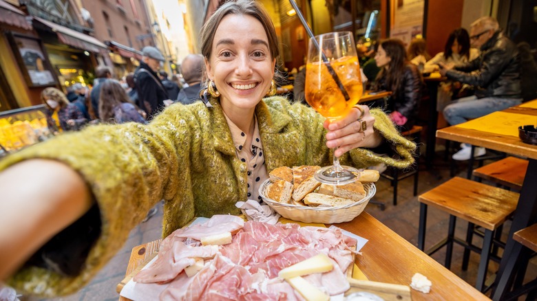Woman eating antipasto, Bologna, Italy