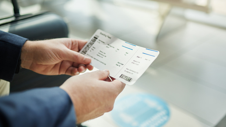 traveler holding boarding pass