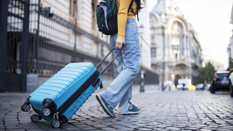 Tourist pulling suitcase