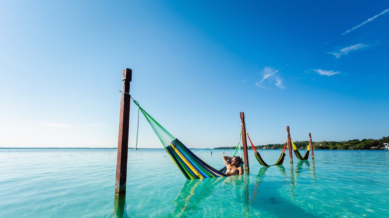 Person lounging in submerged hammock