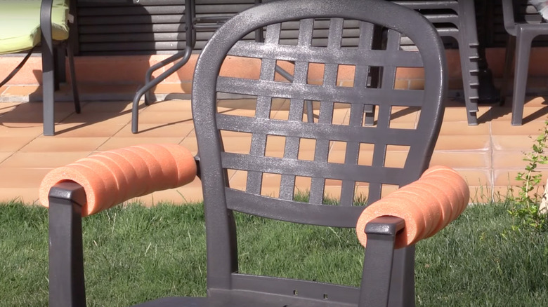Metal chair with noodles on arms