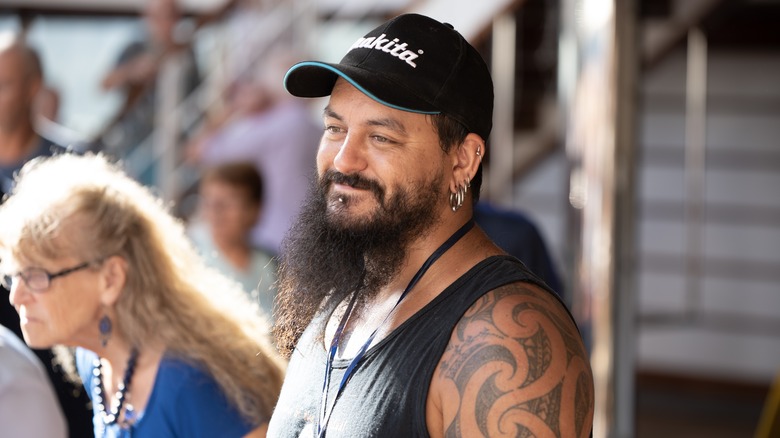 Man with Polynesian tattoos smiling