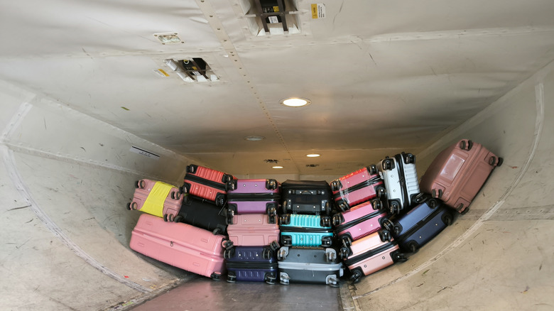 Suitcases stacked in airplane