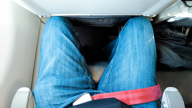 person in cramped plane seat