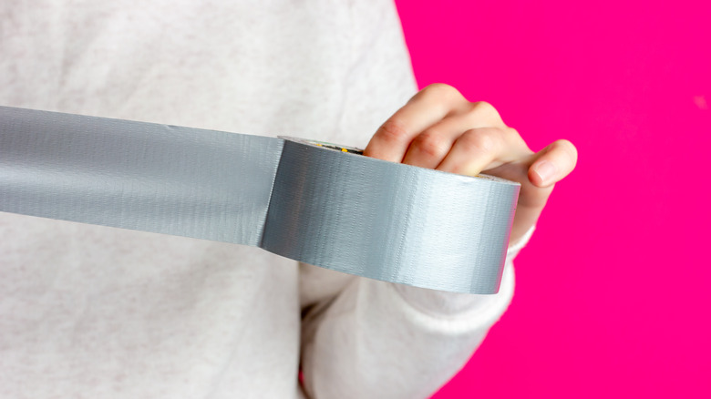 Woman holding roll of tape