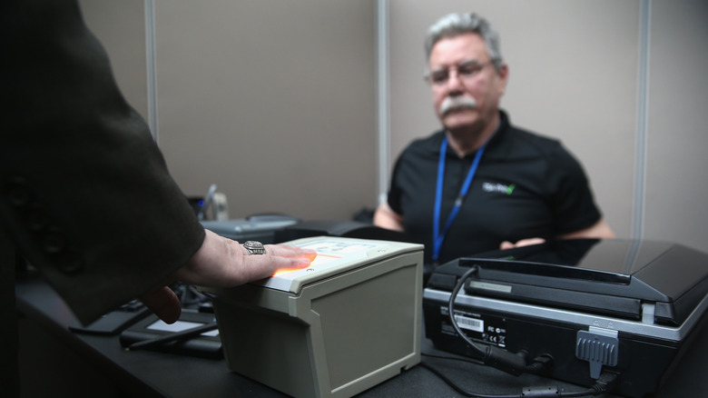 Person scanning fingers at airport