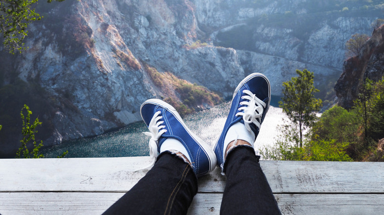 Canvas shoes above river